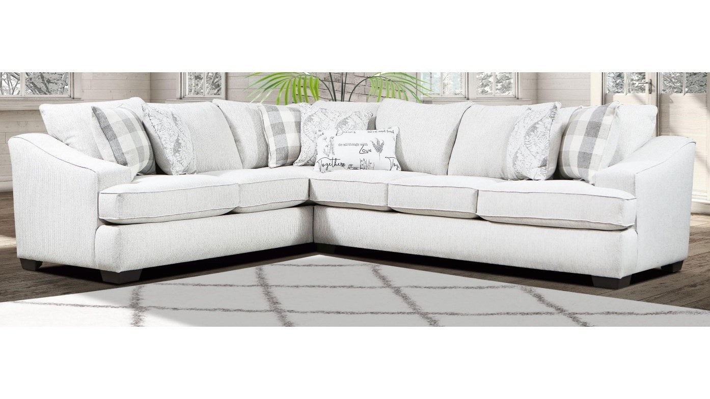 {'index': 2, 'type': 'main', 'description': 'Full view of a light-colored, L-shaped sectional sofa in a bright living room setting, showcasing its modern design and accent pillows.'}