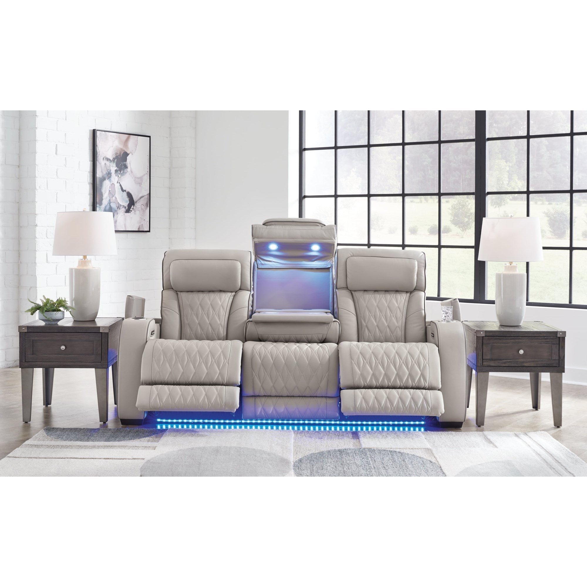 Main product shot showcasing the power reclining loveseat with its built-in console, vibrant blue LED lighting, and inviting greige upholstery, presented in a stylish modern living room setting.