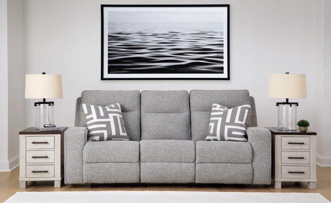Full front view of the 3-seater power reclining sofa in a lifestyle setting, showcasing its modern design and included accent pillows.