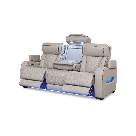Slightly angled view of the sofa on a plain background, highlighting the extended footrests and the drop-down center console with ambient lighting.