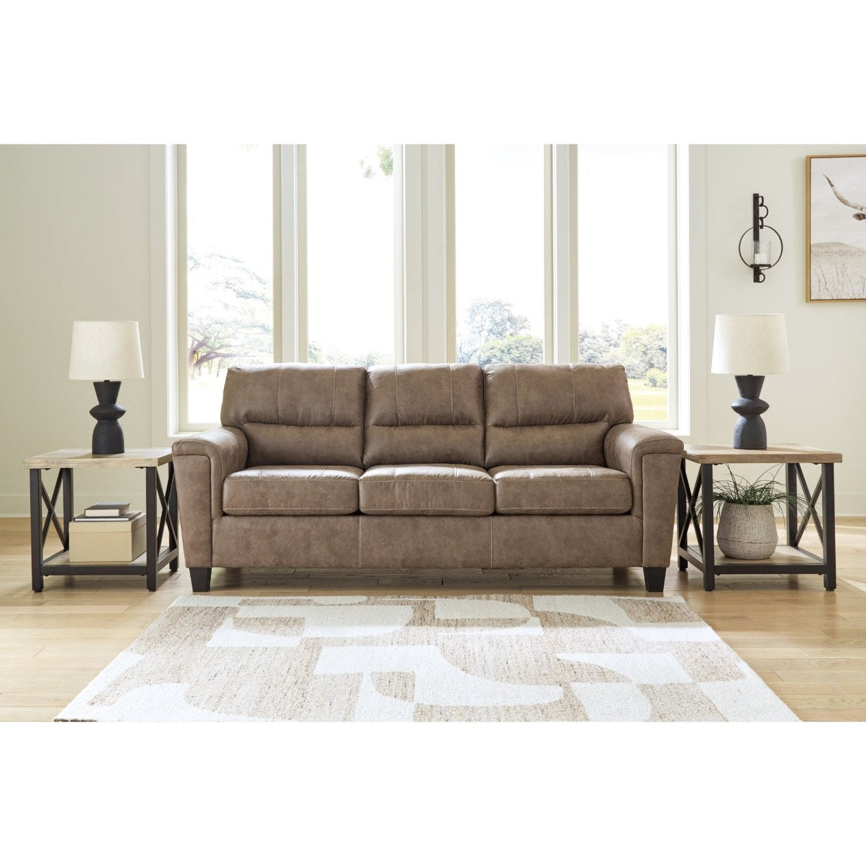 Full front view of a modern three-seater sofa with a warm taupe-brown, distressed faux leather-look upholstery, featuring track arms and dark block feet.